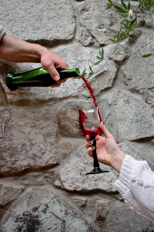 A Person Pouring Red Wine 