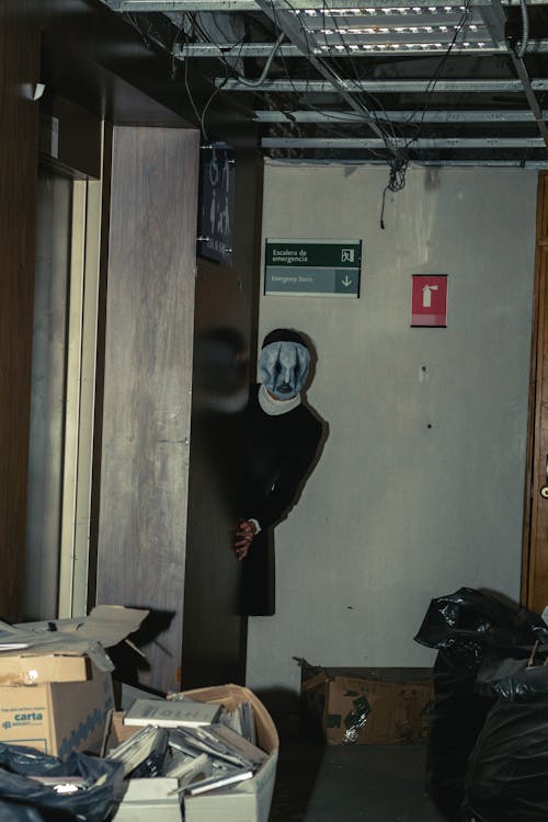 A Person Wearing a Mask in an Abandoned Building