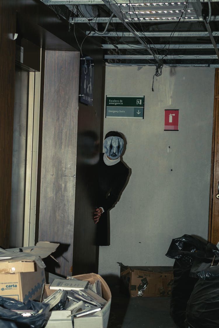 A Person Wearing A Mask In An Abandoned Building