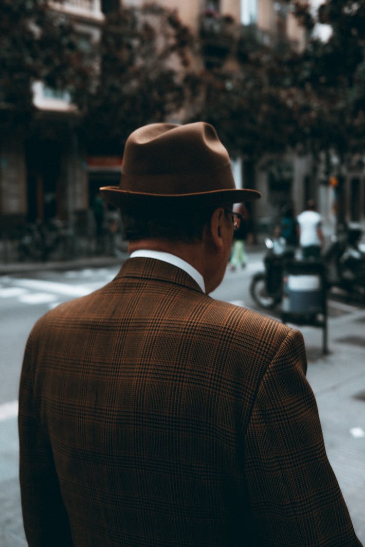 A Man In Brown Plaid Suit Wearing Brown Hat