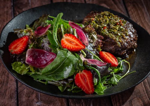 Meat with Salad on Black Plate