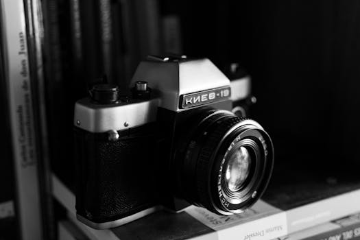 Classic vintage Kiev 19 film camera on a bookshelf in monochrome.