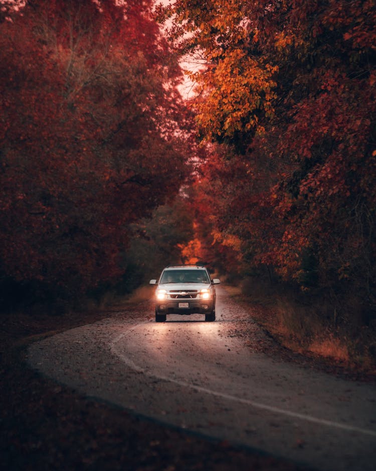 Car Running On A Countryside Road In Autumn