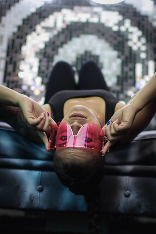 Woman Lying Down Wearing a Pink Sunglasses