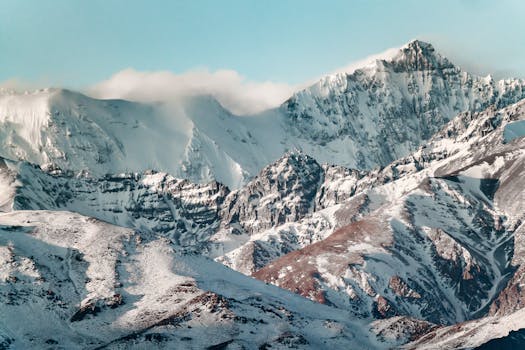 Breathtaking view of snow-covered Andes mountains near Santiago, Chile, under a clear blue sky.