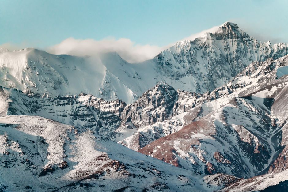 Breathtaking view of snow-covered Andes mountains near Santiago, Chile, under a clear blue sky.