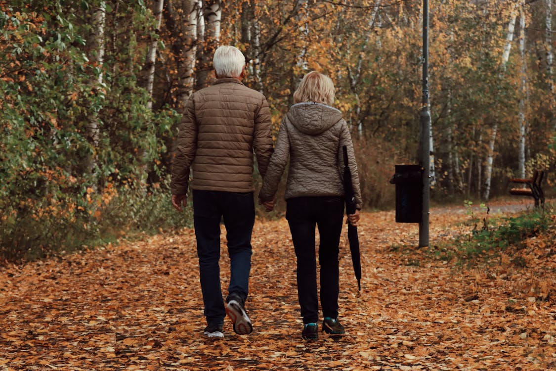 Couple Holding Hands While Walking · Free Stock Photo