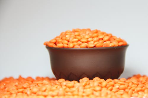 Free Orange Beans in Black Ceramic Bowl Stock Photo