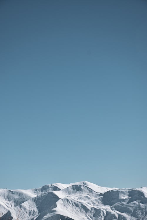 Free Blue Sky and Mountains in Snow Stock Photo