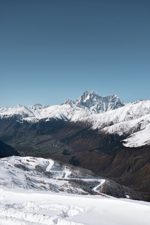 Rocky Mountains in Snow and Winding Road