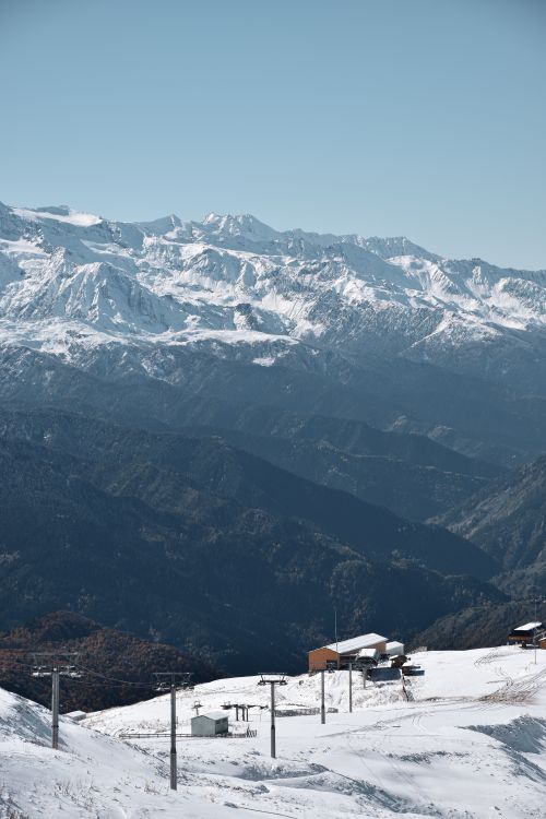 Free Breathtaking view of snowy mountains and ski resort in winter landscape. Stock Photo