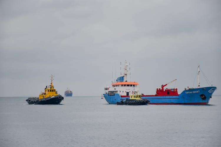 Cargo Ships Sailing On Sea