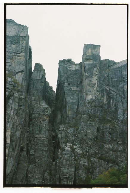 Stunning vertical view of majestic cliffs in Norway, offering a natural landmark scene.