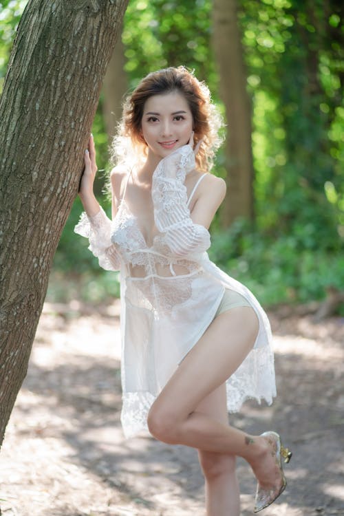 Cute Brunette Woman in Underwear Posing in Park · Free Stock Photo