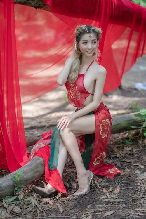 A Woman in Red Crop Top Smiling at the Camera