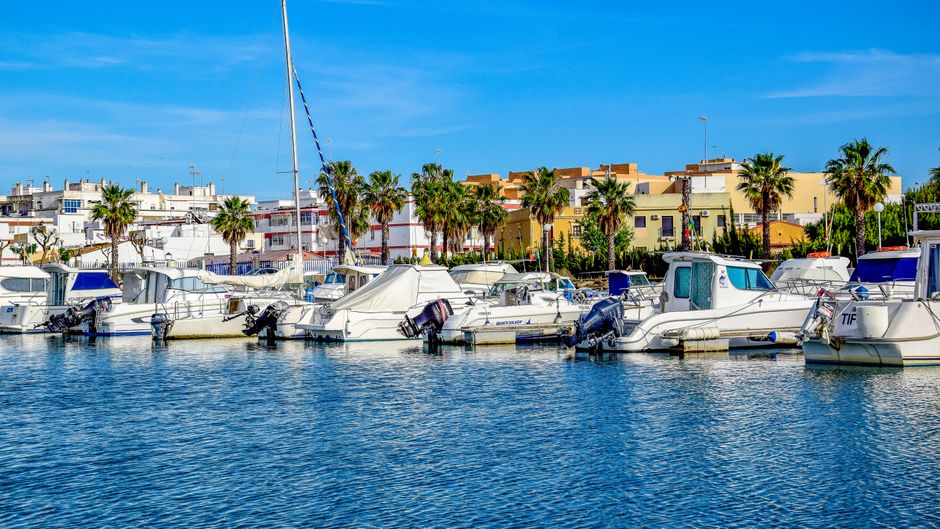 Spectacular Sunset Sailing Yacht Experience Small Group Review: Gran Canaria's Golden Hour Magic Review 2026 - Colorful boats docked in Isla Cristina harbor on a sunny day.