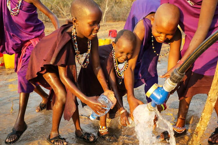 A Group Of  Kids Fetching Water