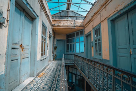 Charming indoor hallway with wooden doors and decorative tiles. Vintage architecture detail.