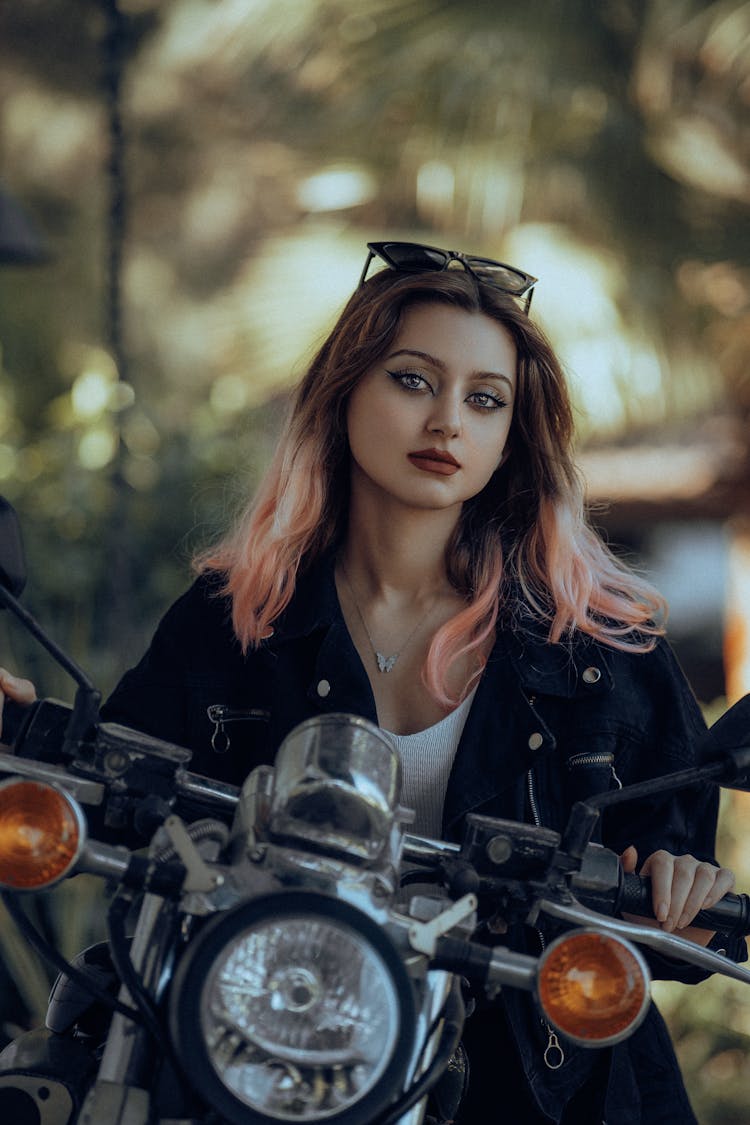 Girl Sitting On Bike Outdoors