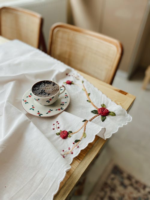 Ceramic Cup and Saucer with Coffee on the Wooden Table