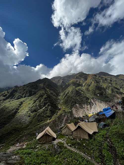 A Camping Tents on Mountain Under the Blue Sky and White Clouds