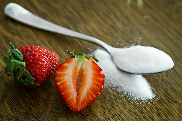 Strawberry Beside Spoon Of Sugar