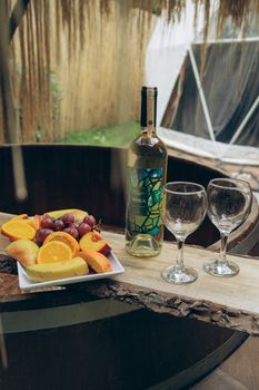 A stylish arrangement of wine, glasses, and fresh fruit outdoors in Istanbul.