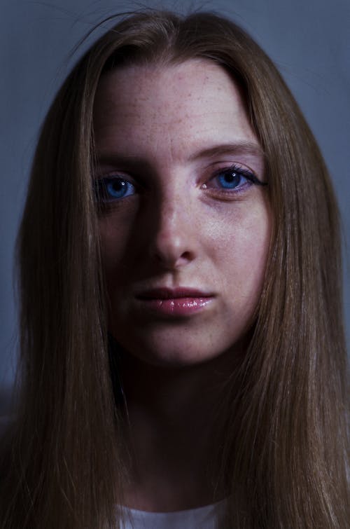 Close Up Photo of Woman with Blue Eyes