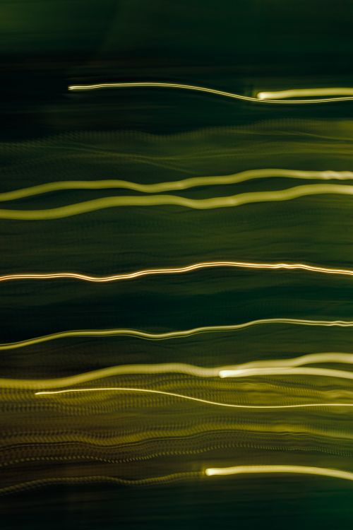 Free Dynamic abstract green light trails creating an artistic motion effect. Stock Photo
