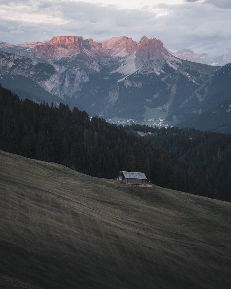 House On Hill In Mountain Landscape