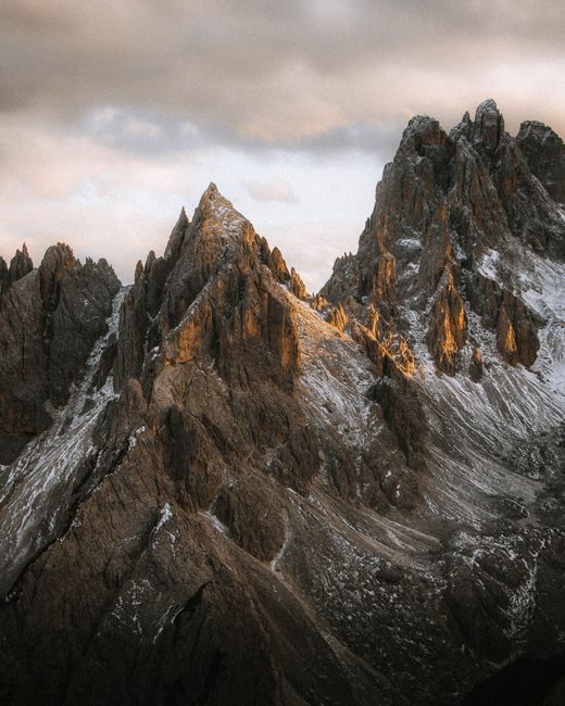 Breathtaking view of the rugged peaks in Misurina, Italy, lit by the warm glow of sunset.