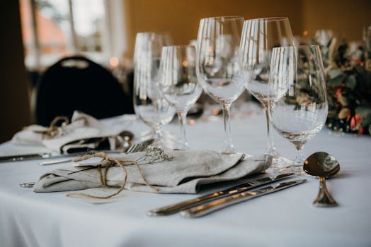 A classy table setup with fine cutlery, napkins, and elegant wine glasses ideal for formal dining.