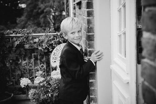 Black and White Photo of Boy Wearing Suit