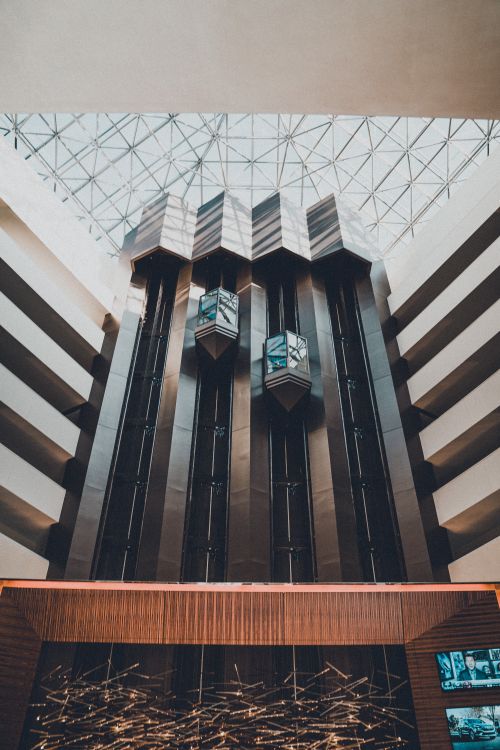 Glass lifts inside a modern multi-storey building