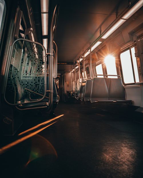 Free Sun-drenched train interior showcasing empty seats and modern design, ideal for public transit themes. Stock Photo