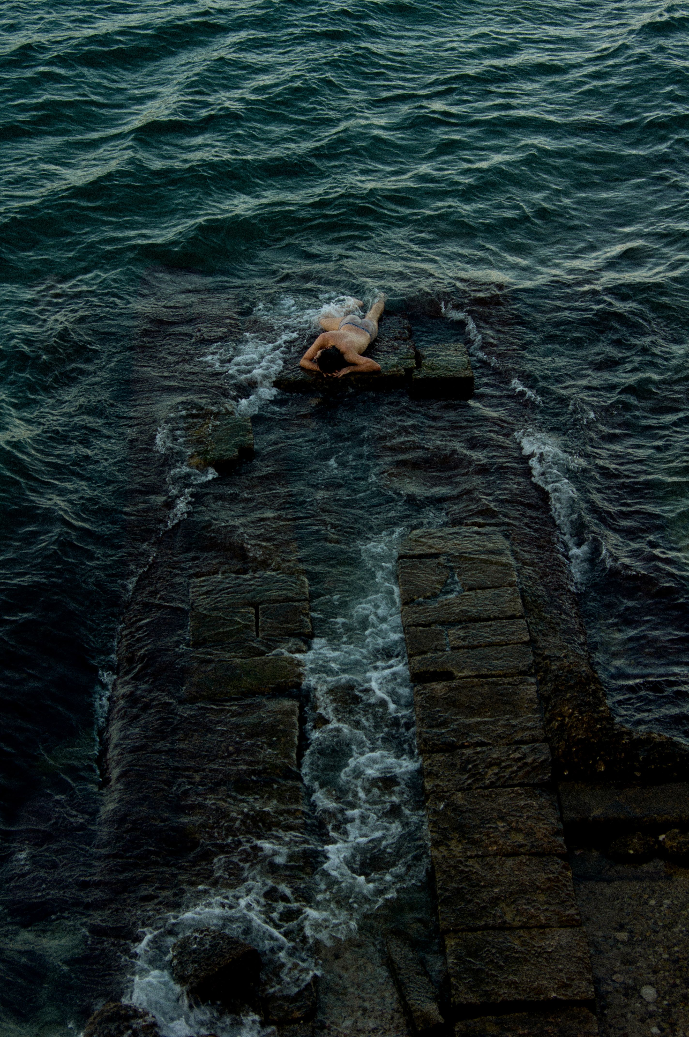 Man Lying on the Rock in the Sea · Free Stock Photo