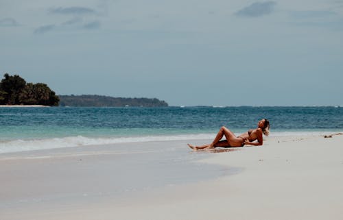 A Woman Sunbathing at the Beach 