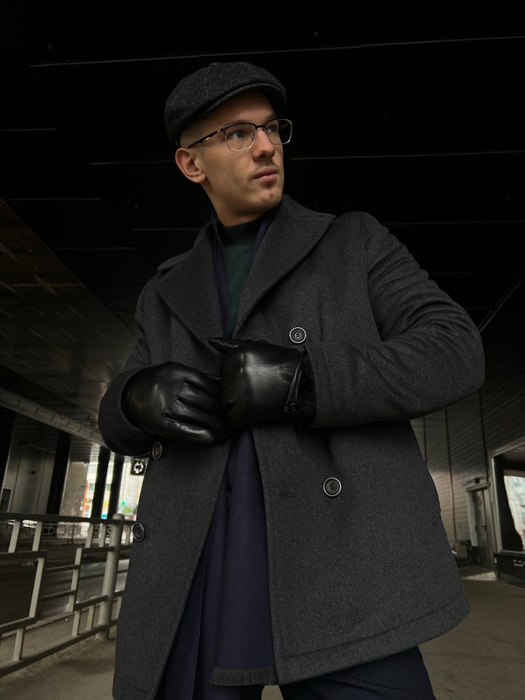 A Man Wearing Coat And A Flat Cap