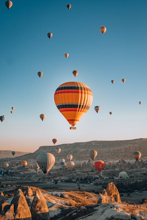 Hot Air Balloons Flying in Sky above Mountains