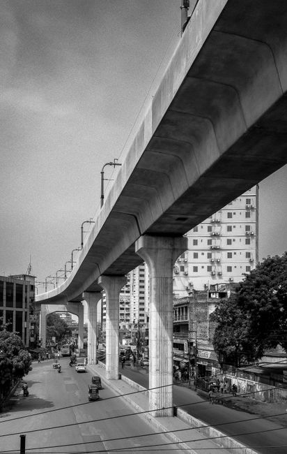 Black and white view of Dhaka's elevated highway, highlighting urban architecture and city streets.