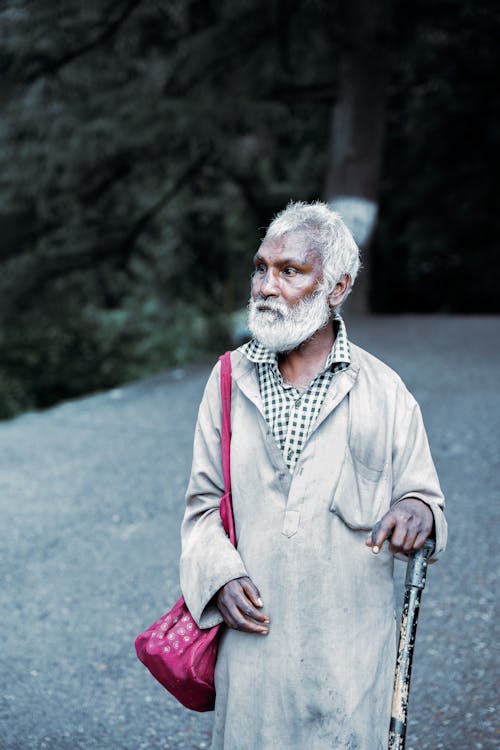Elderly Man Roaming with a Cane