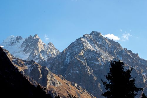 Free Stunning mountain landscape with snow capped peaks under a clear blue sky. Stock Photo