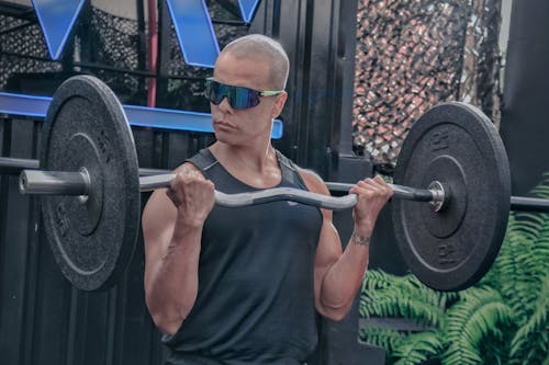Photo of Man Lifting a Barbell