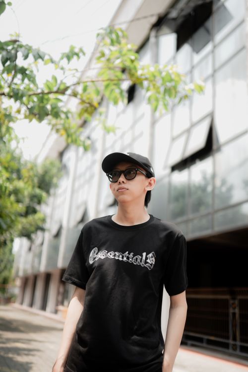 Free Casual outdoors portrait of a young adult wearing sunglasses and a black shirt in an urban environment. Stock Photo