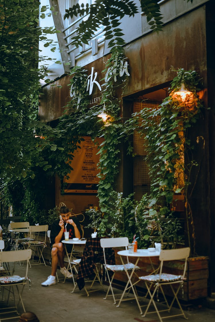 A Man Drinking Coffee At The Coffee Shop