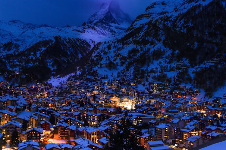 Illuminated Town Houses In Mountain Landscape