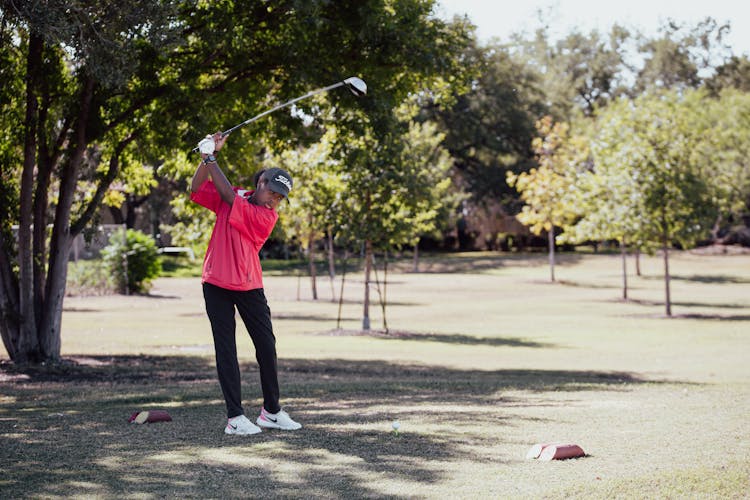 Girl Golfer Swinging A Golf Club