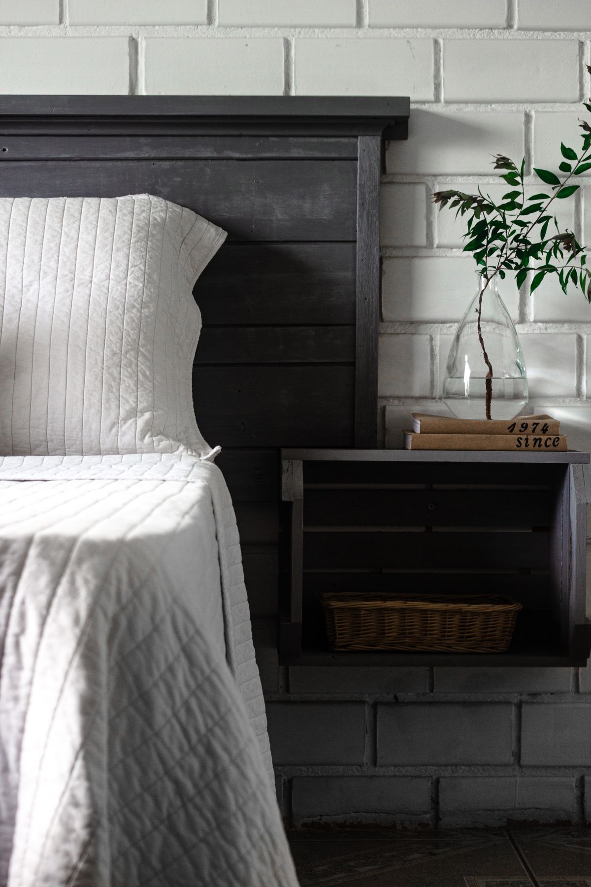 Minimalist floating bedside table in a small bedroom