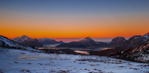 Photo of Snow Capped Mountains during Dawn