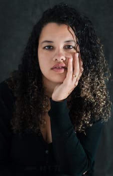 A captivating portrait of a woman with curly hair and a thoughtful expression.